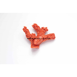 Carved woman face on red coral